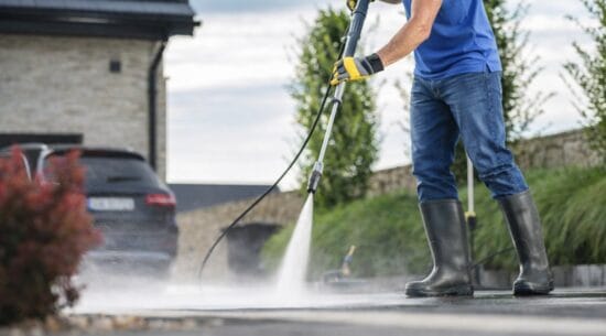 Man Pressure Washing Driveway